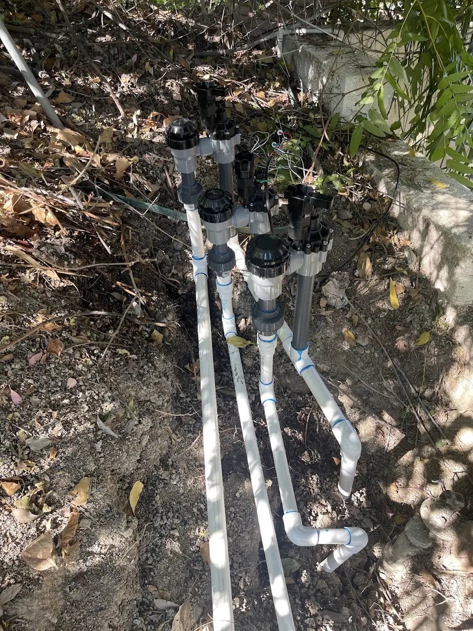 Rebuilt sprinkler valve manifold with new PVC pipe at a Calabasas home