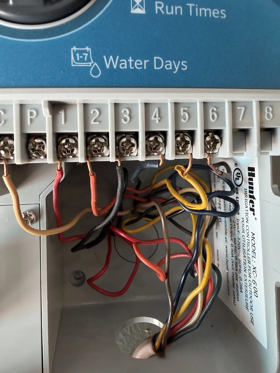 Hunter sprinkler controller with valve wires connected to its zone terminals