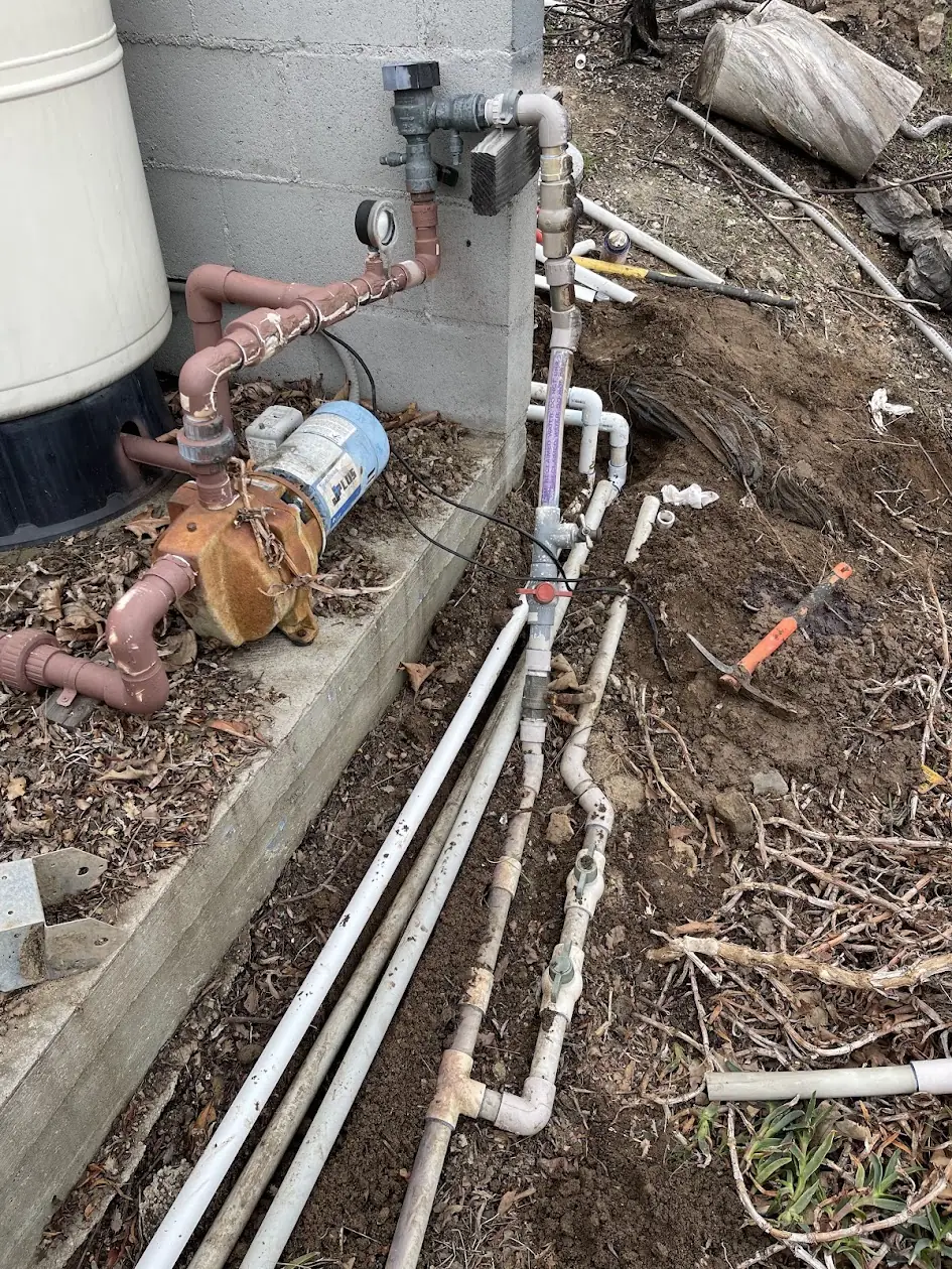 New sprinkler lines being run along a house after wildfire damage in Malibu