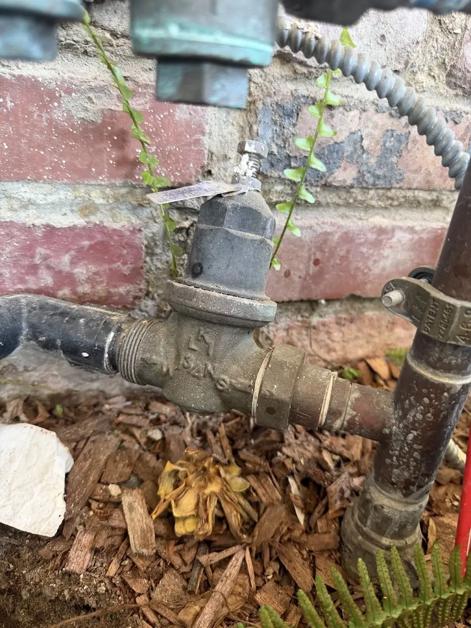 Old water pressure regulator on a house supply line, ready for replacement