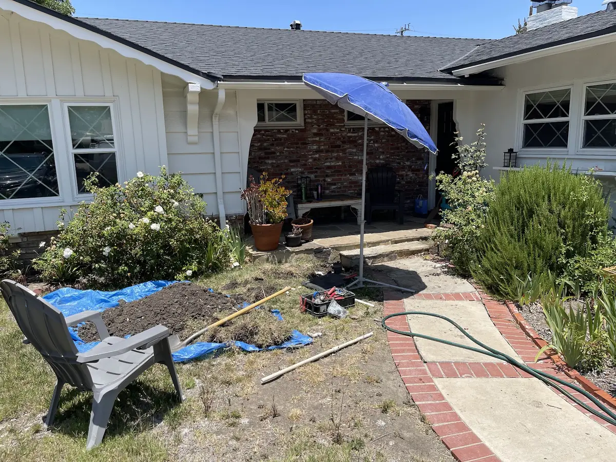 Front-yard dig to run a new sprinkler pipe under the walkway